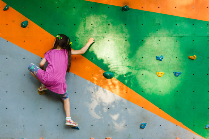 A girl getting ready to rock climb at her favorite place.