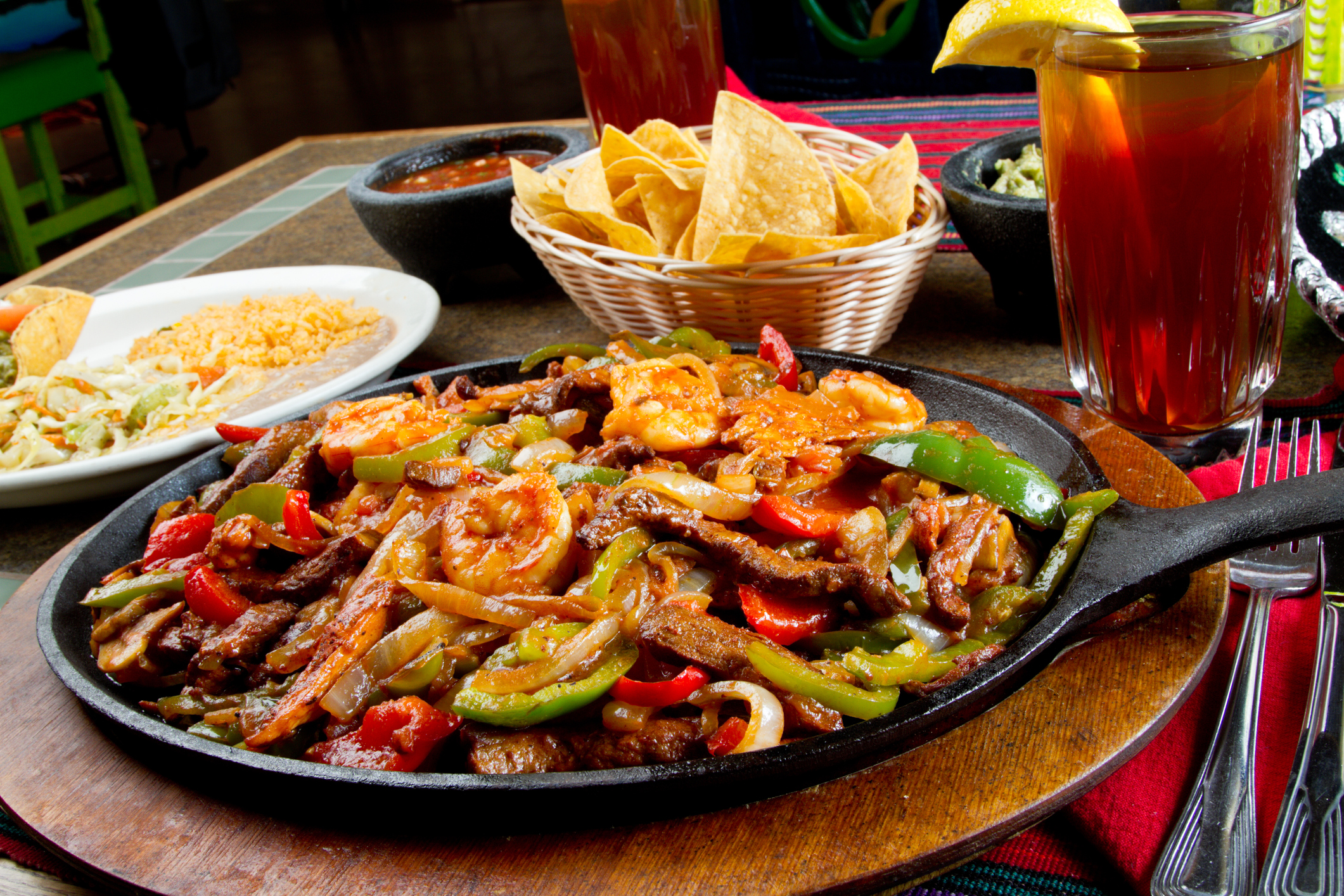 Shrimp, beef and chicken Mexican fajitas.