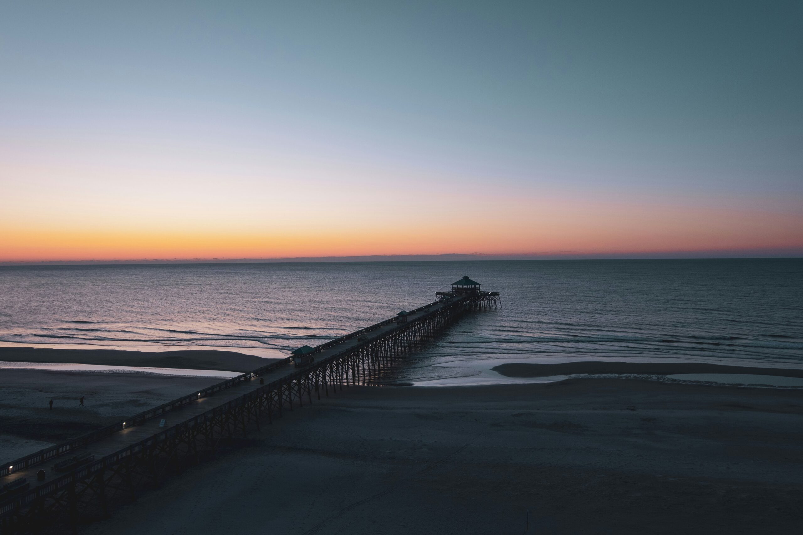 Sunset view of Folly Beach Pier in Folly Beach, South Carolina.