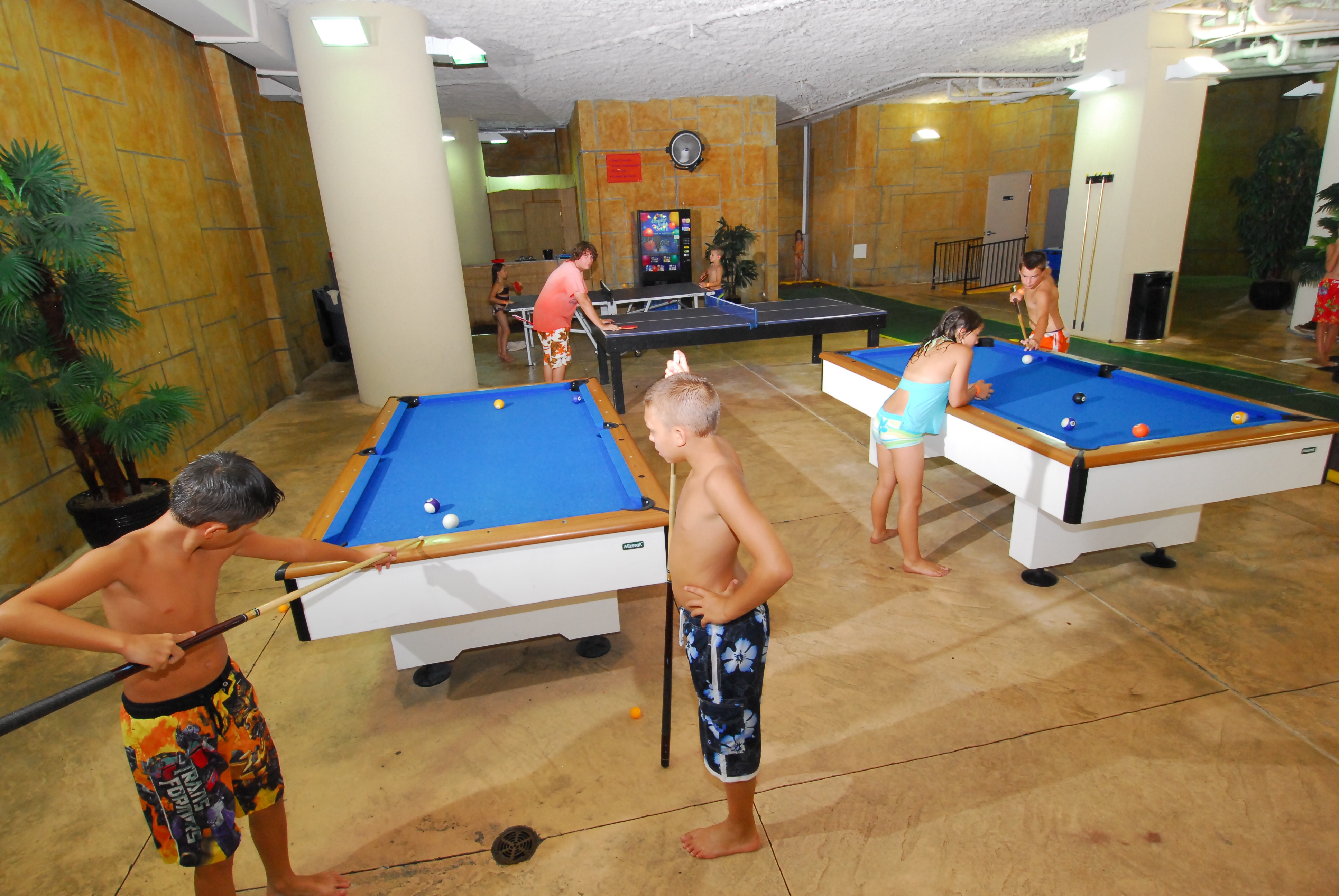 Kids playing pool and table tennis at Dunes Village Resort Myrtle Beach.
