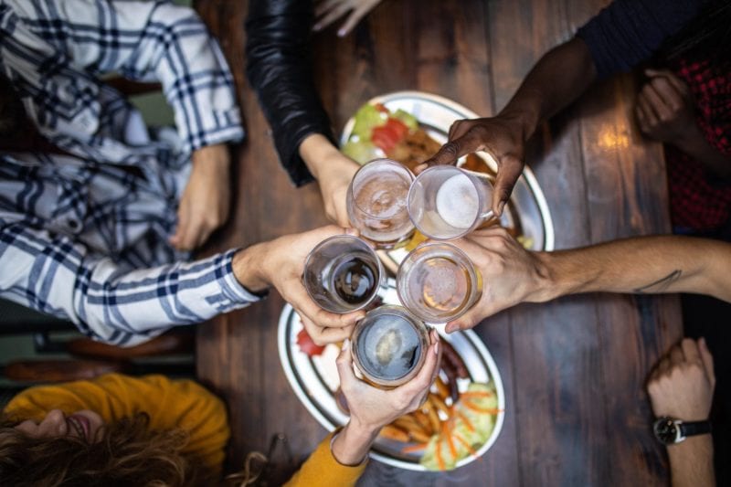 Friends cheers while dining at the Market Common