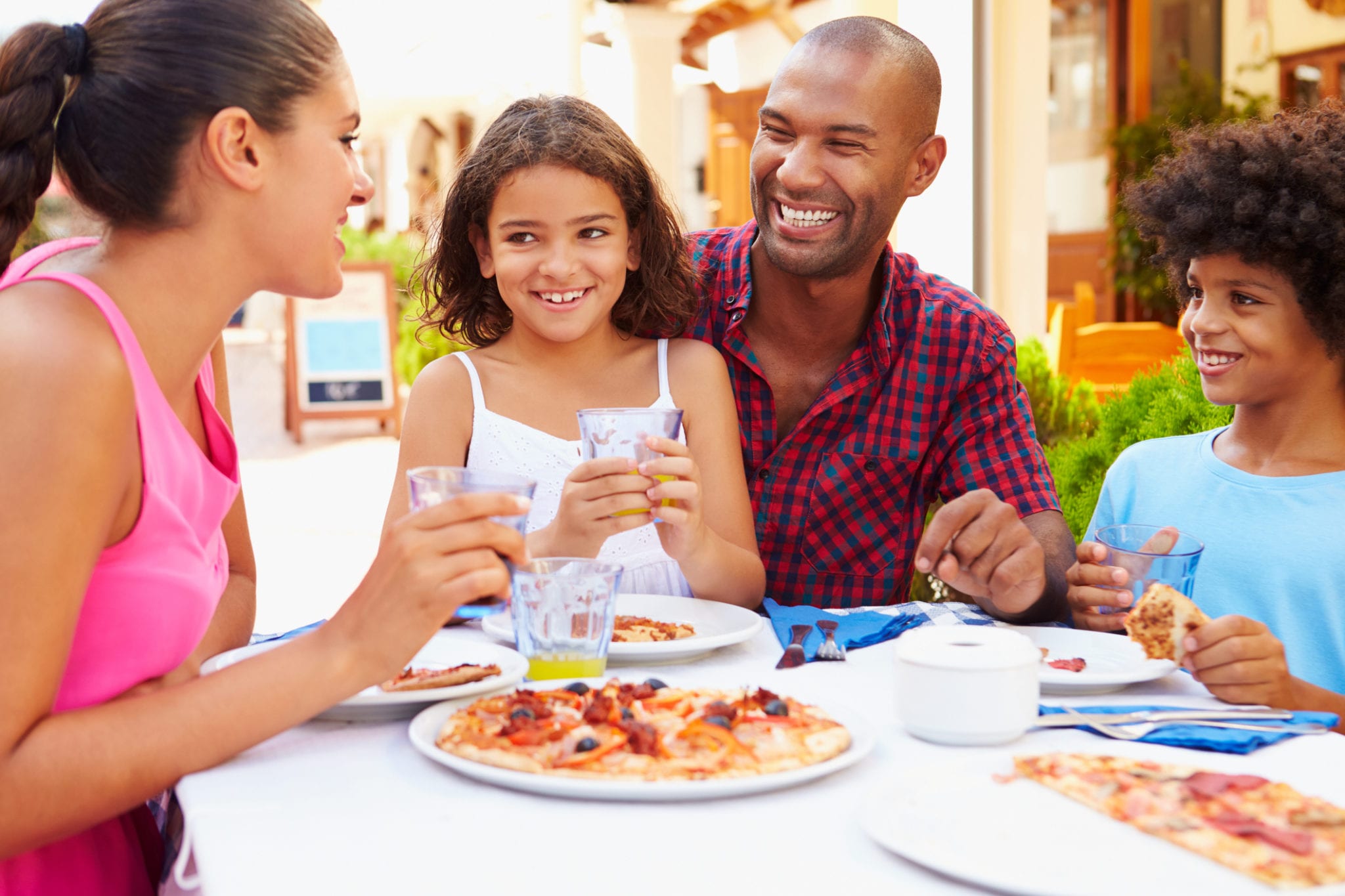 family eating at restaurant at broadway at the beach