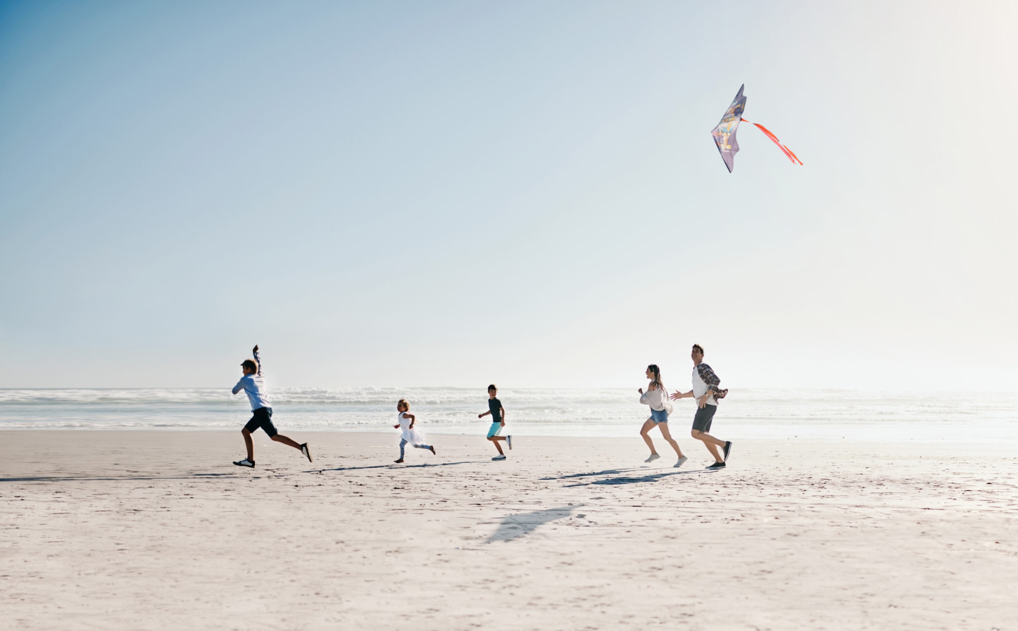 Myrtle Beach Family Activities, family running and flying kite on the beach