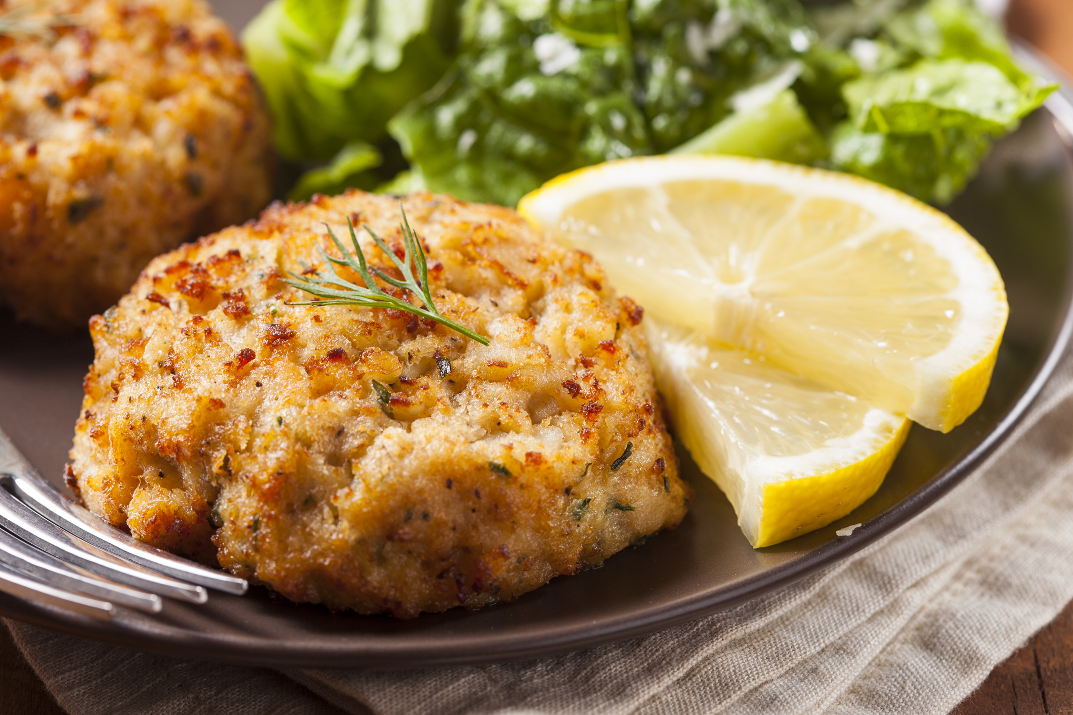 Plate of lump crab cakes and lemon.