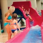 Girl sliding down water slide at Dunes Village Resort Waterpark in Myrtle Beach.